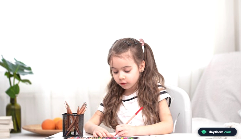 The girl is sitting at the table and doing homework.