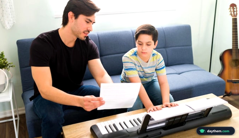 Learning to play a new song on the piano. Artistic young boy talking with his music teacher during a private lesson