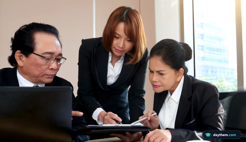 Cán bộ công chức đang ngồi làm việc bàn giấy, xem xét tài liệu và giấy tờ tại cơ quan nhà nước.