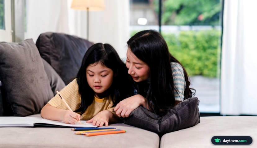 Asian middle-aged woman teach her daughter do homework and drawing at home