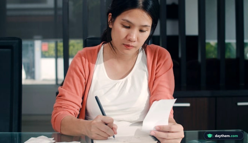 Young Asian Pregnant woman records of income and expenses at home. Mom girl happy using laptop record budget, tax, financial document, e commerce working in living room at home .