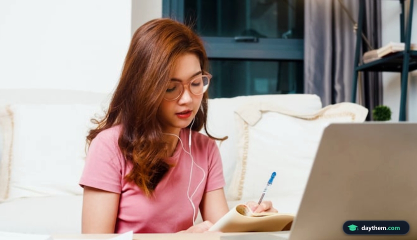 Young Asia teen girl student wears headphones distance learning lesson with online teacher on laptop